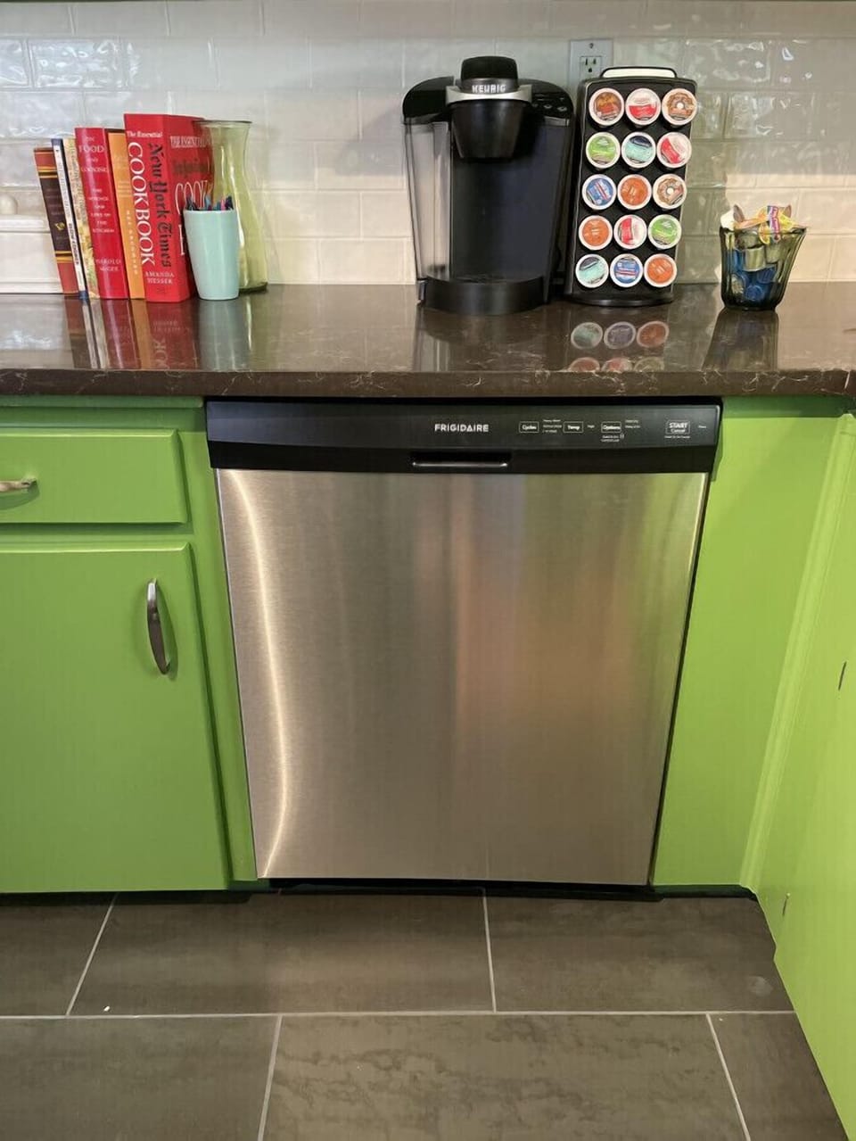 This kitchen is iconic with its vintage rodeo wallpaper, stainless steel appliances, Keurig, microwave, and retro breakfast table for four.