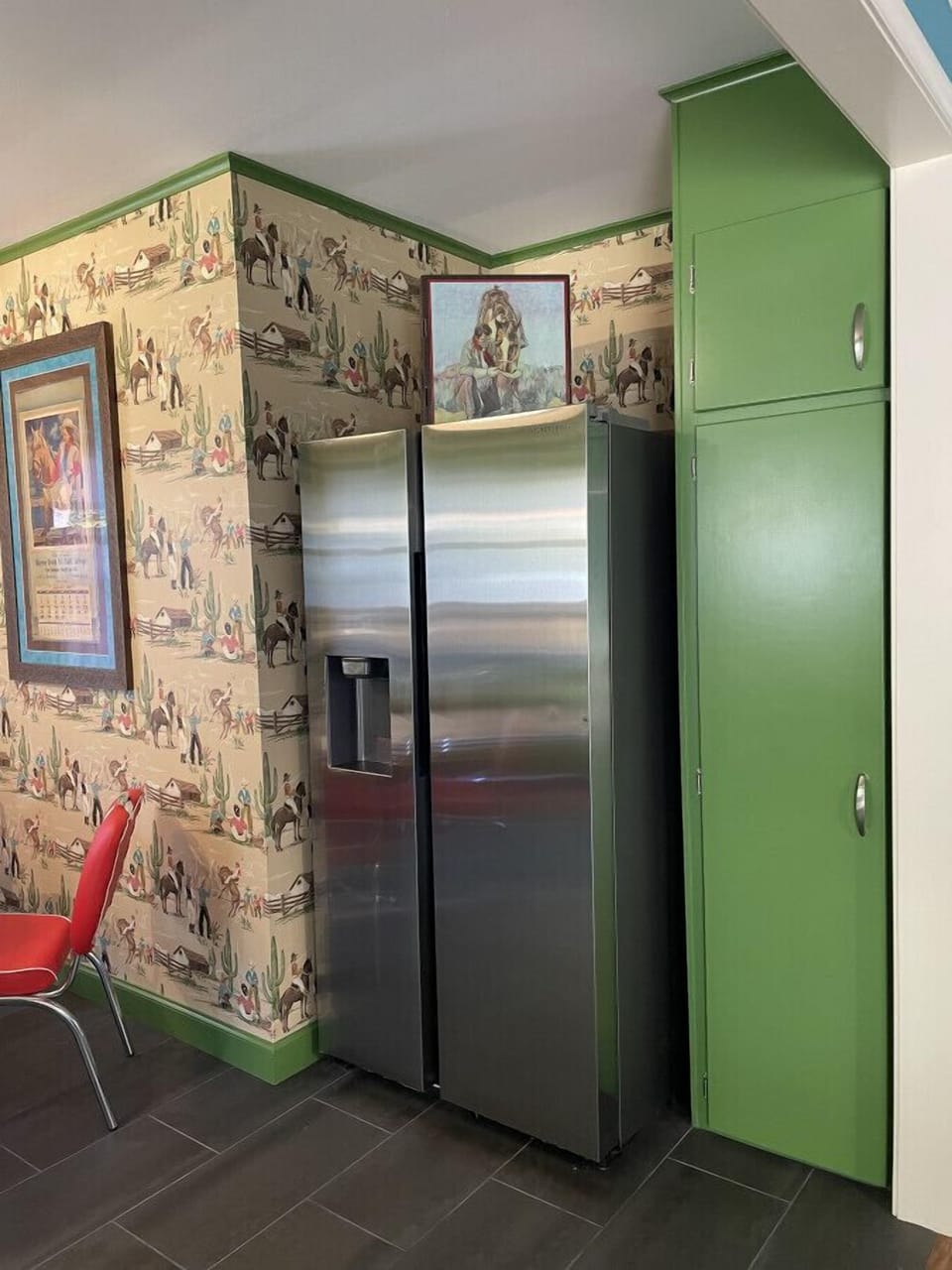 Cleaning supplies are located in the tall cabinet to the right of the fridge.
