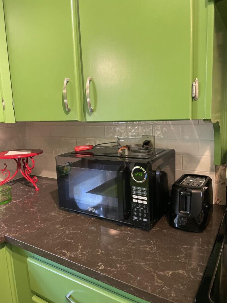 Holding all the comforts of home, well-equipped cupboards are stocked with flatware, glassware, plenty of mugs for coffee and tea, a Pioneer Woman dish collection, a full set of pots and pans, and even a few cookbooks for inspiration.