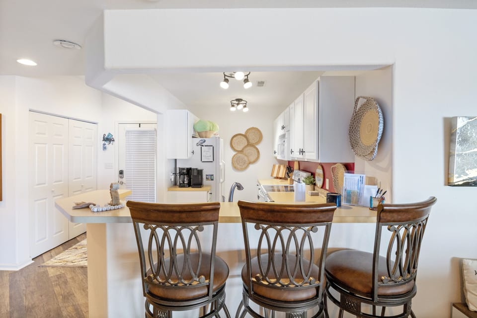 Great gathering spot in the kitchen with a center island and trendy bar stools.