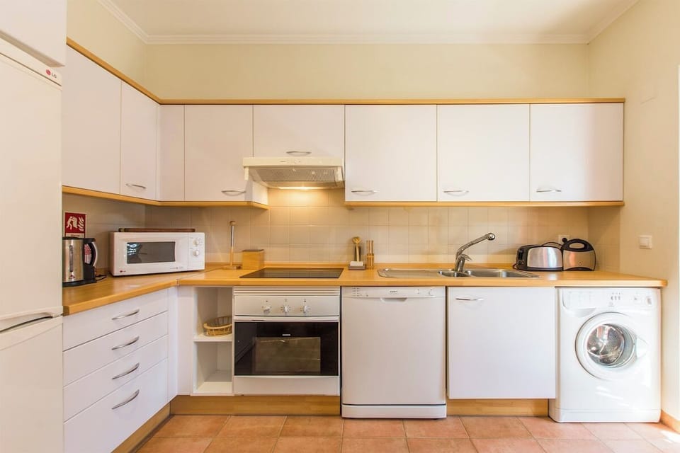 Spacious and fully equipped kitchen with dining area.