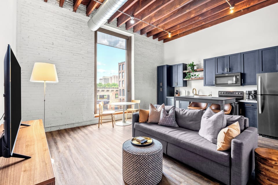 Chic lounge space with dramatic windows & panoramic Arch backdrop.