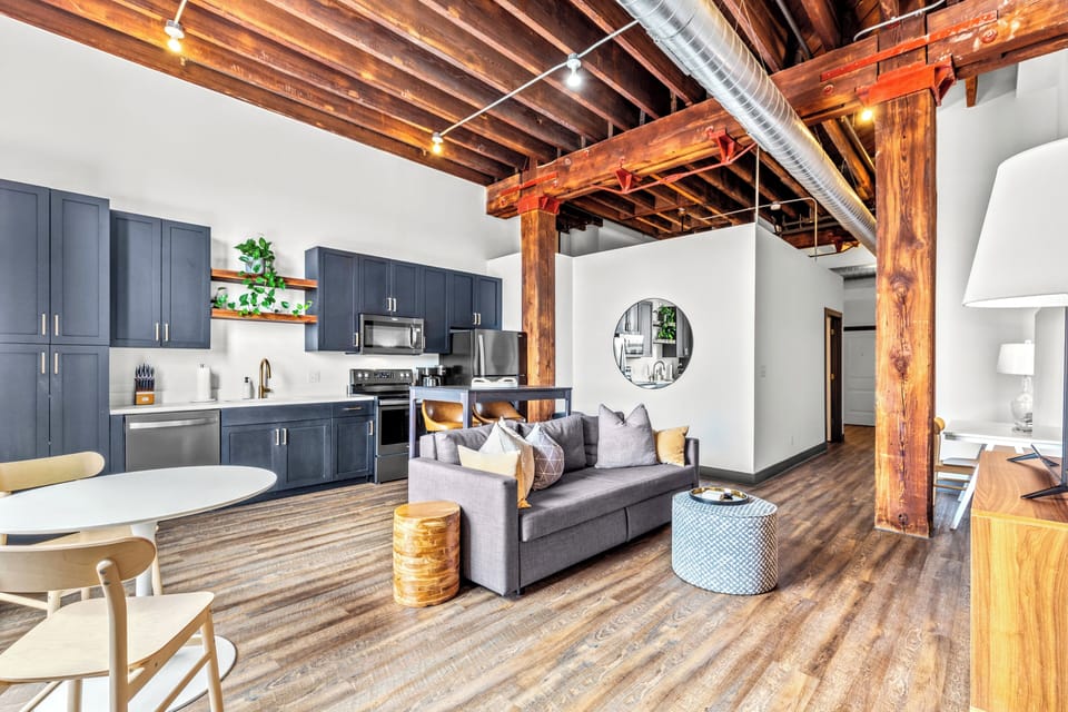 Spacious, sunlit living area with historic, exposed beams