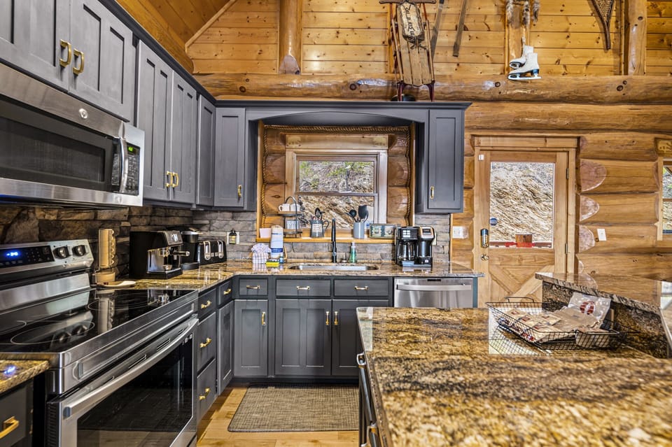 Cook up a storm in this fully equipped kitchen, featuring modern appliances, sleek countertops, and a window that frames the rugged beauty of the outdoors.