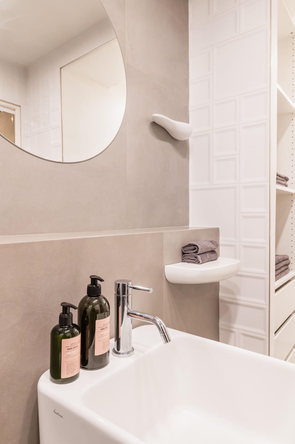A large mirror, quality products, a scale, a hair dryer and a towel dryer.