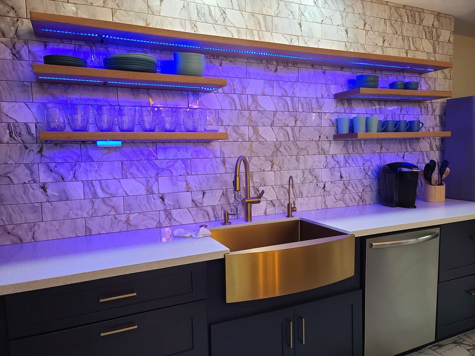 A luscious kitchen with LED lighting , silverware,  basic spices and coffeeMaker