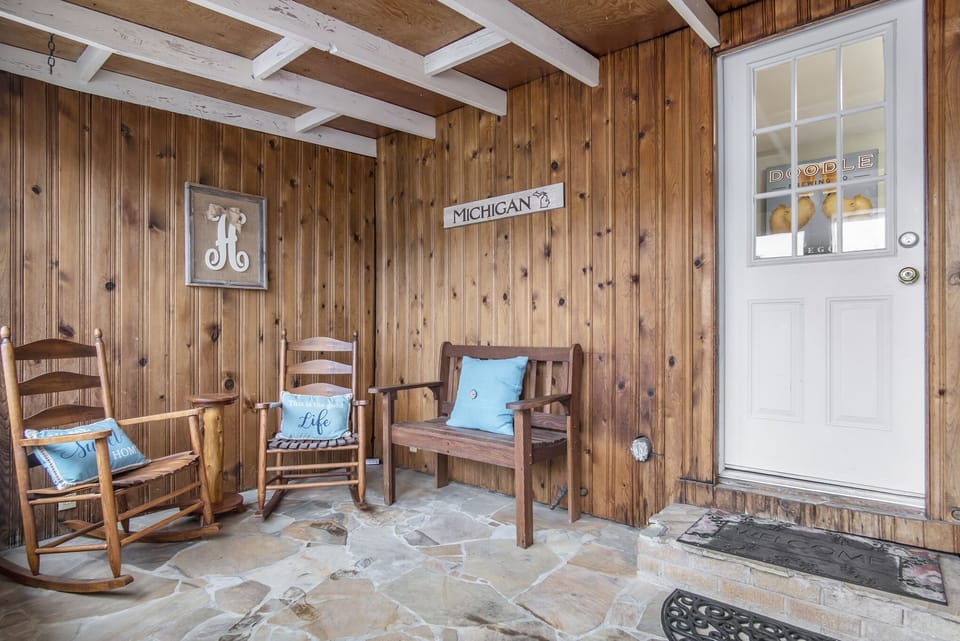 Off the rear of the home, an enclosed back porch accompanied with rocking chairs