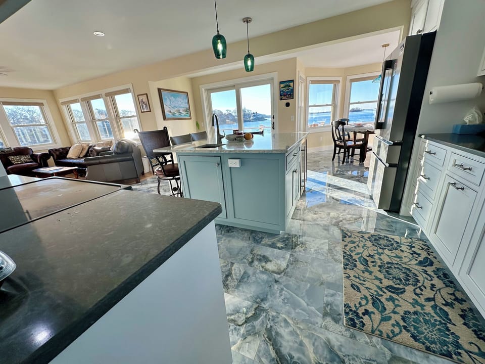 Kitchen , living room , island seating and dining all open to views and  deck