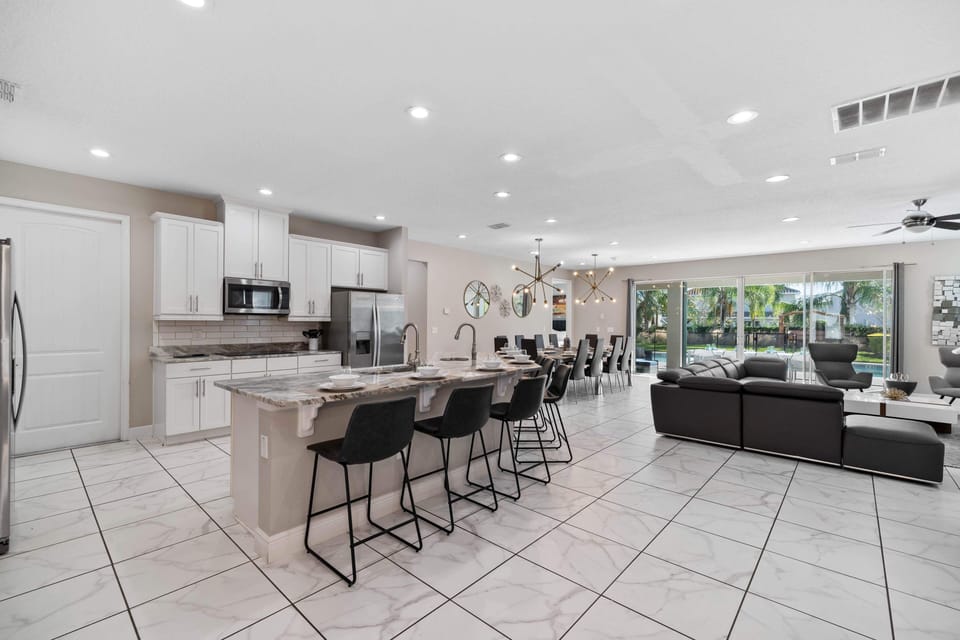 - Open kitchen with granite countertops and bar seating  
- Stainless steel appliances and plenty of prep space  
- Flows into dining and living for group entertainment