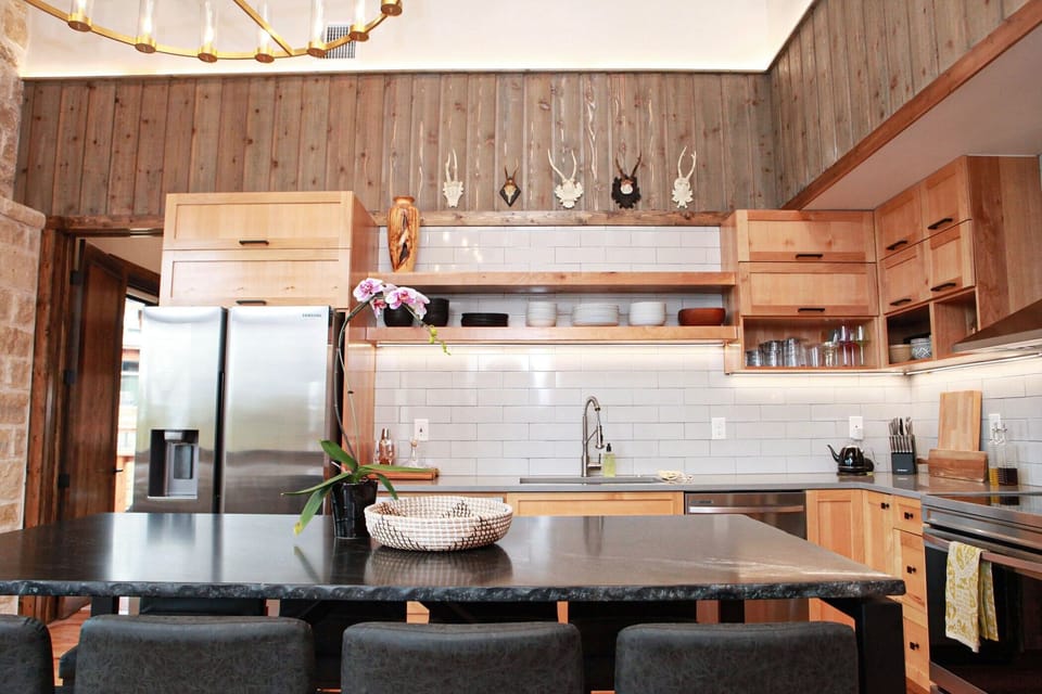 Indoor bar-height dining table with kitchen in the background.