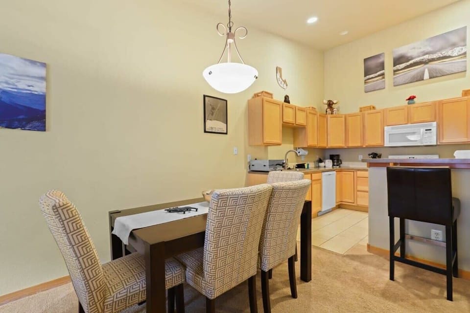 A kitchen island with 2 bar stools and a dining table with seating for 6 provides ample space for your group to enjoy meals together.