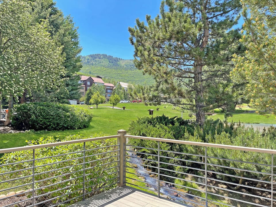 Heading out the door of the dining room, you'll be on the private deck with a grill where you'll be able to enjoy the sound of running water from the stream!