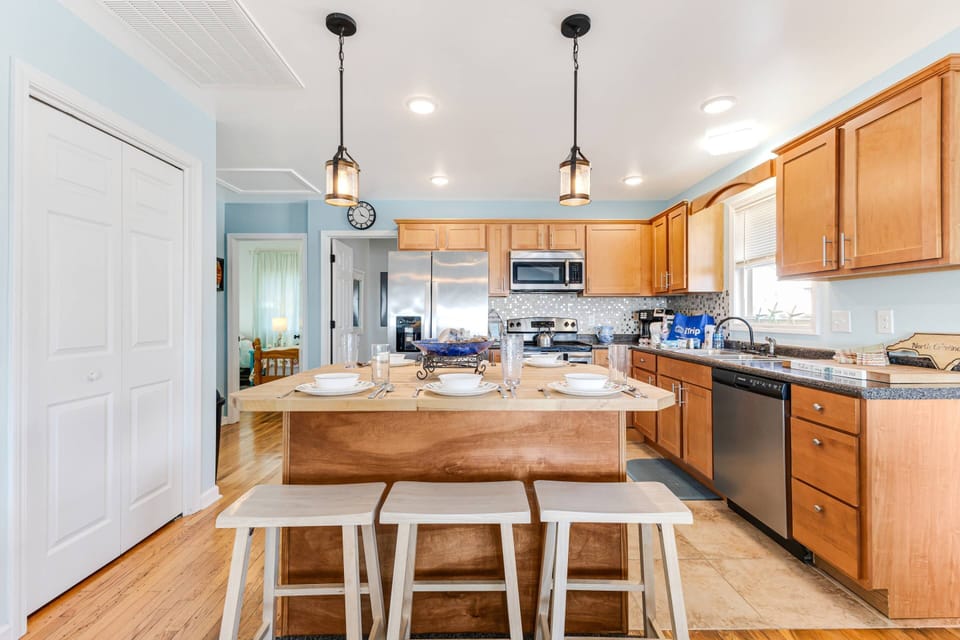 To the left of the dining island is the stacked washer/dryer laundry center. Save room for souvenirs by packing lighter.