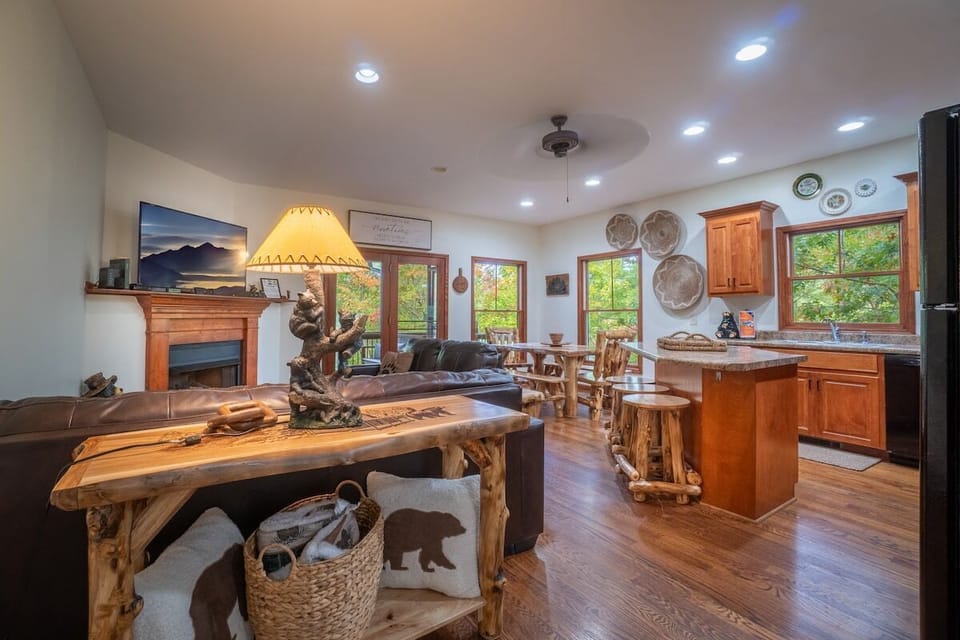 Kitchen on main floor with comfy couches, smart TV, and table.
