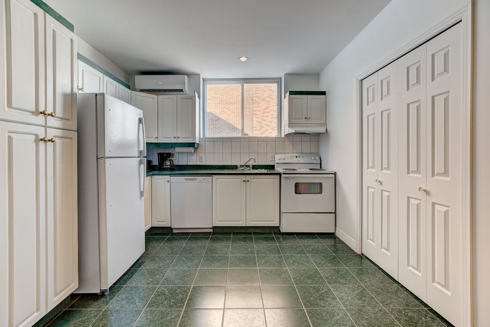 Kitchen with an adjacent laundry room