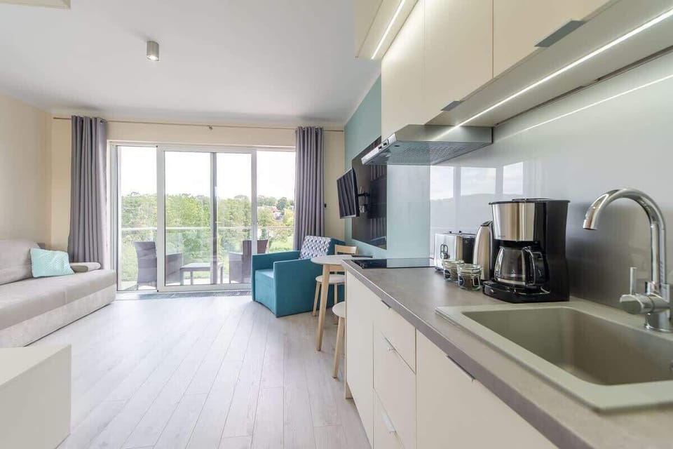 Kitchenette with plenty of kitchen utensils and dishes.
