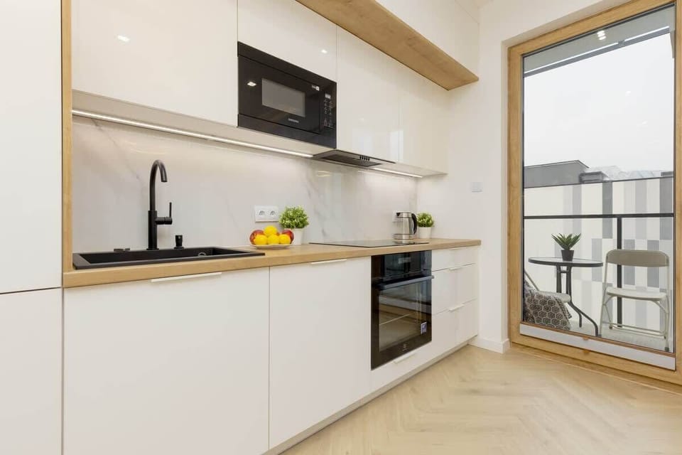  Another angle of the kitchen area, showing a modern oven and other stainless steel appliances.