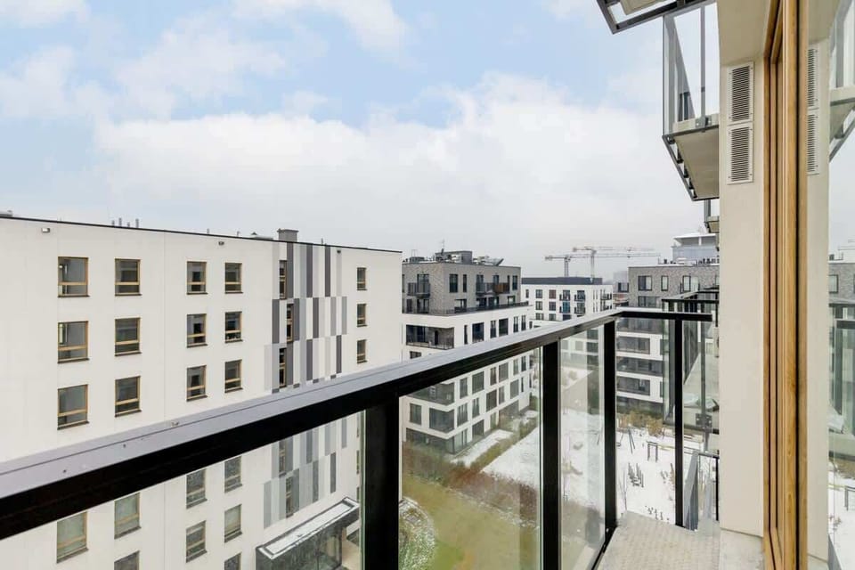 Balcony overlooking the street, providing an expansive view of neighboring buildings.
