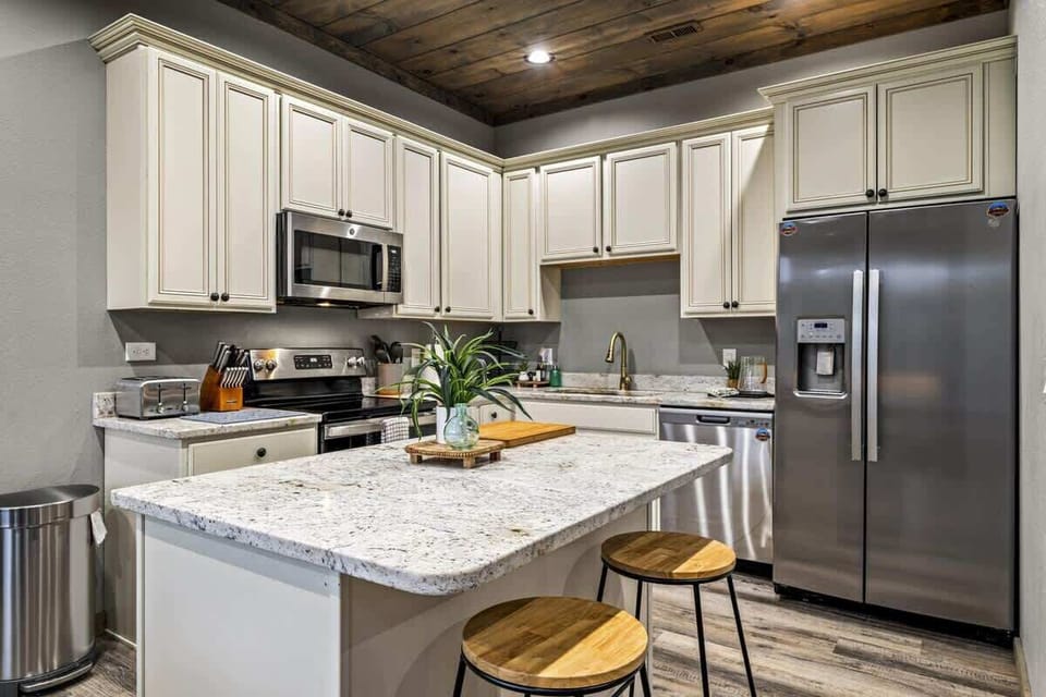 Whip up your favorite meals in this fully equipped kitchen featuring granite countertops, stainless steel appliances, and rustic charm.