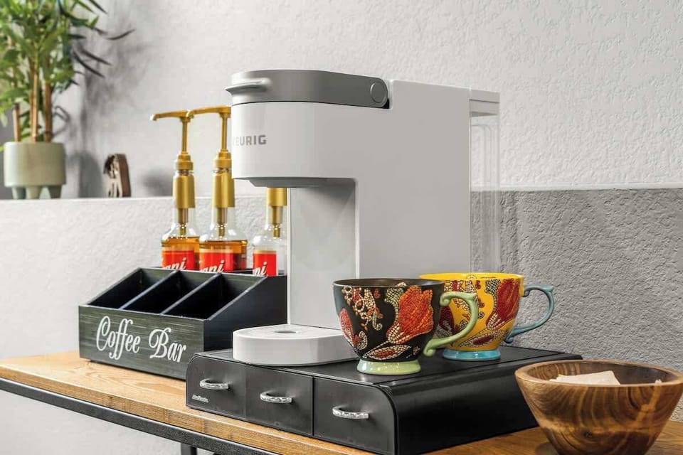 Create your perfect cup at the fully stocked coffee bar, complete with artisan mugs and your favorite flavors.