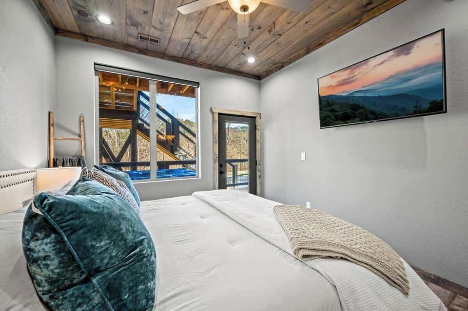 Wake up to treetop views and step right out to the hot tub from this peaceful bedroom retreat—your mountain escape starts here.