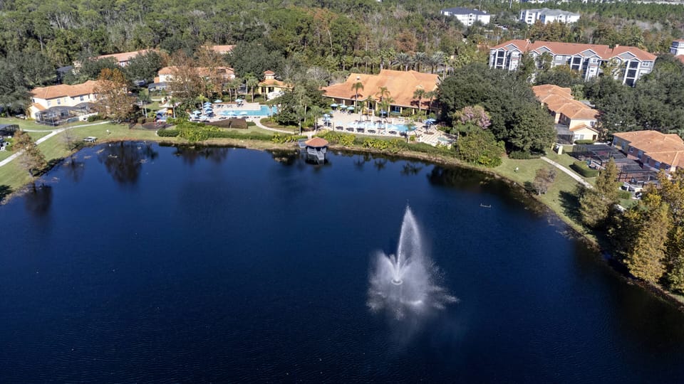 Experience the serene ambiance of the tranquil lake, surrounded by lush greenery and vibrant landscaping. The charming fountain enhances the peaceful atmosphere, providing a perfect backdrop for relaxation and stunning views from.