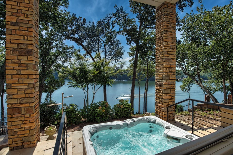 Lakefront retreat with private hot tub and stunning water views. Relax among trees, enjoy peaceful surroundings, and unwind in your outdoor spa. Perfect for romantic getaways or a serene escape by the lake.
