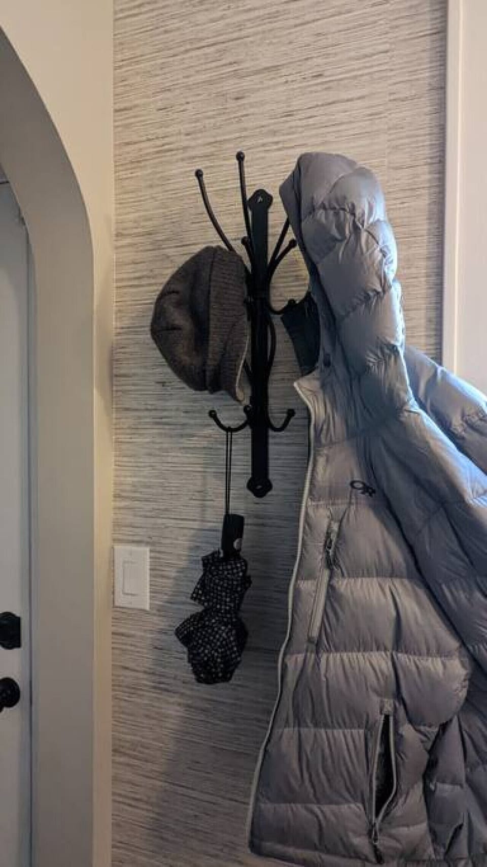 Coat rack just off the back side of the kitchen before the rear entrance of the home