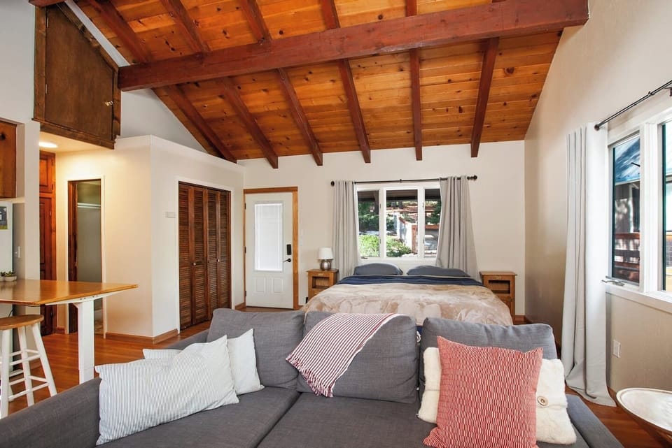 ABOVE GARAGE STUDIO - The studio features a king bed, a sofa bed, a wood-burning fireplace, full bathroom with walk-in shower and a breakfast bar dining area. 