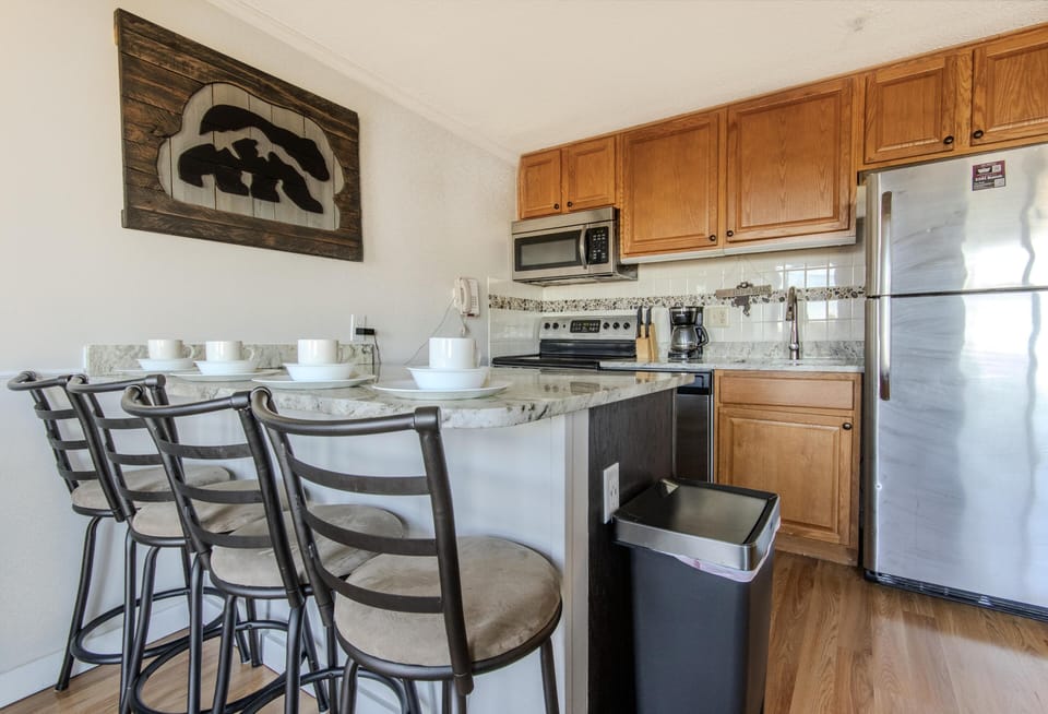 Completely renovated kitchen with updated countertops and an island with seating for four people.