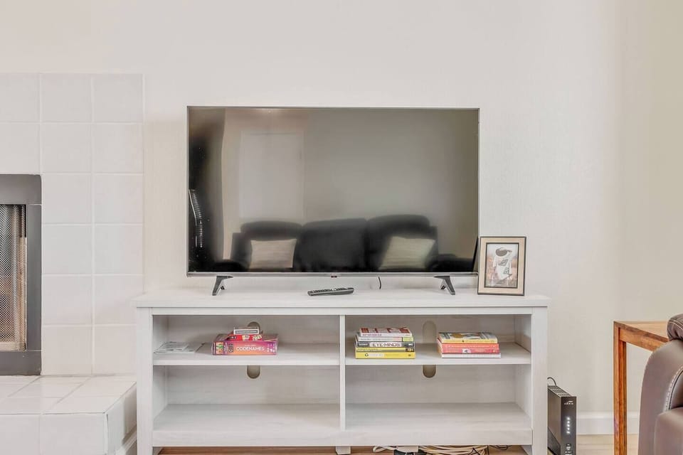 Immerse yourself in entertainment with a 50" LG Smart TV, enhancing the cozy living room experience. Whether it's movies or games, the ample screen invites enjoyment for all.