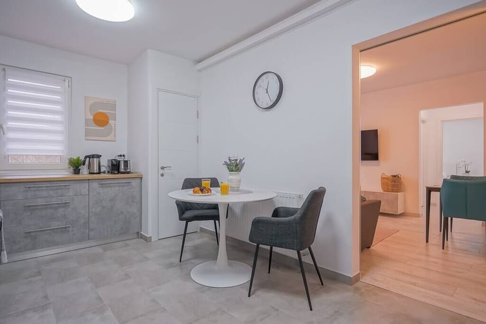 Fully equipped kitchen with fridge, freezer, oven, stove, coffee espresso machine, toaster, water kettle, microwave, cooking utensils, cooking basics and dining table.
