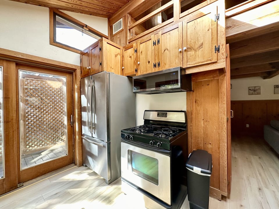 Kitchen has gas stove, fridge, coffee pot, toaster oven/air fryer