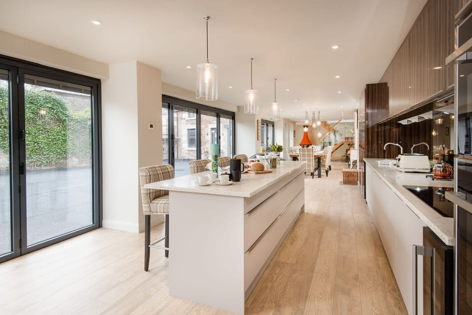 Coledale Stables - the open-plan kitchen and dining area with bi-fold doors overlooking the courtyard