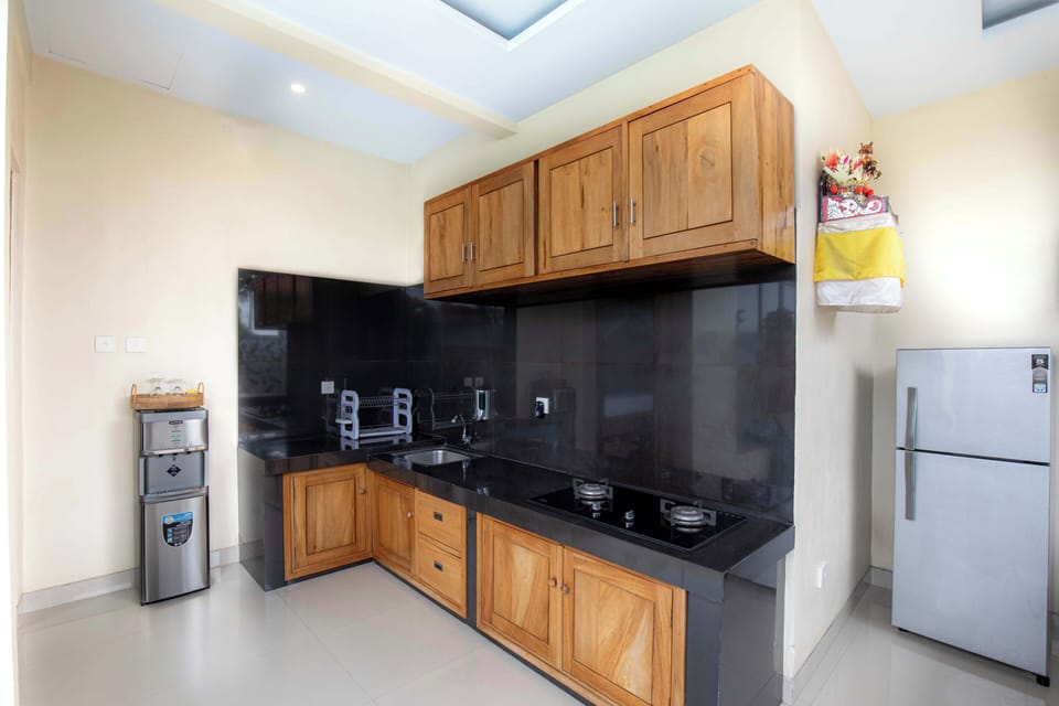 Deluxe Villa | Private kitchen | Full-size fridge, stovetop, electric kettle, griddle