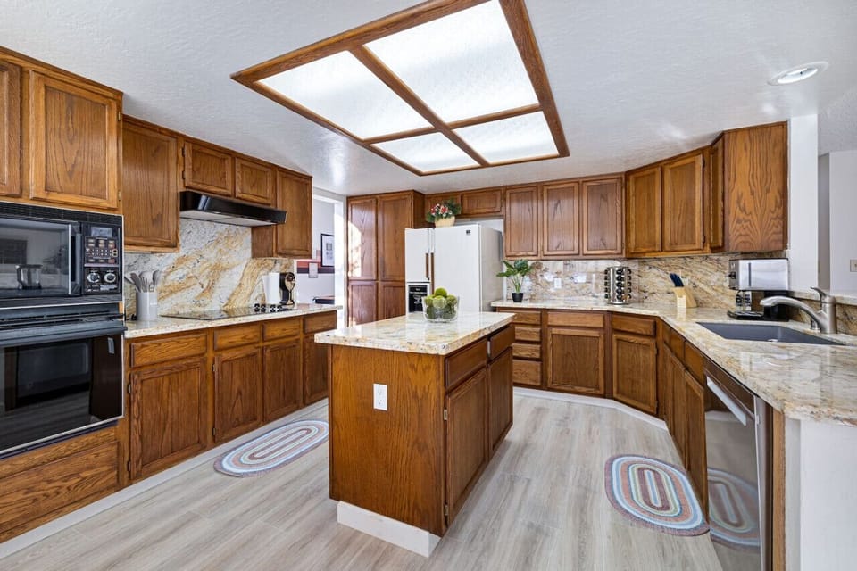 Wooden and modernly equipped kitchen with a skylight.