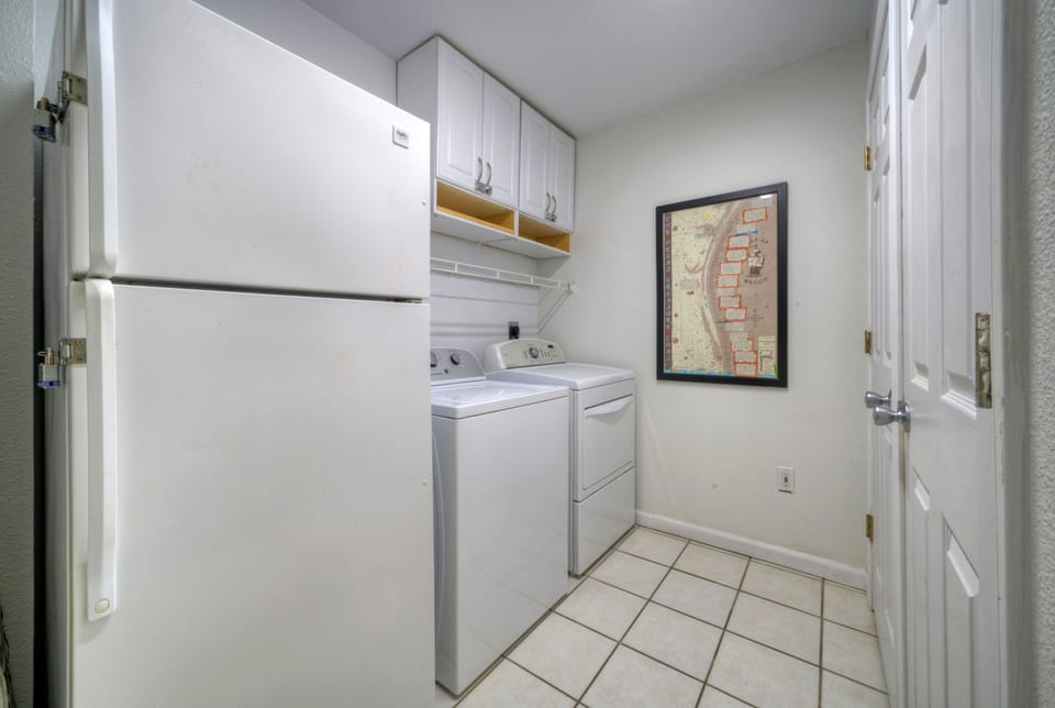 Laundry room offers a washer and dryer.