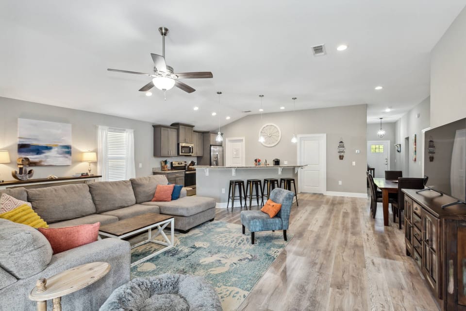 Large open concept living area, dining table and kitchen