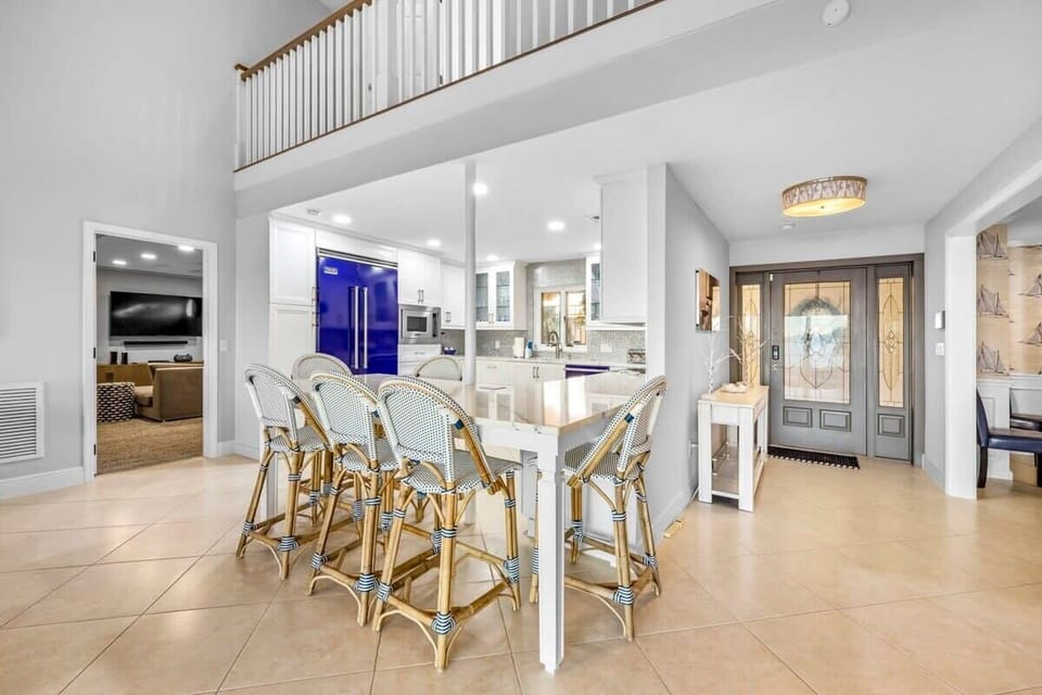 Open kitchen and dining area with a large island and seating for six.