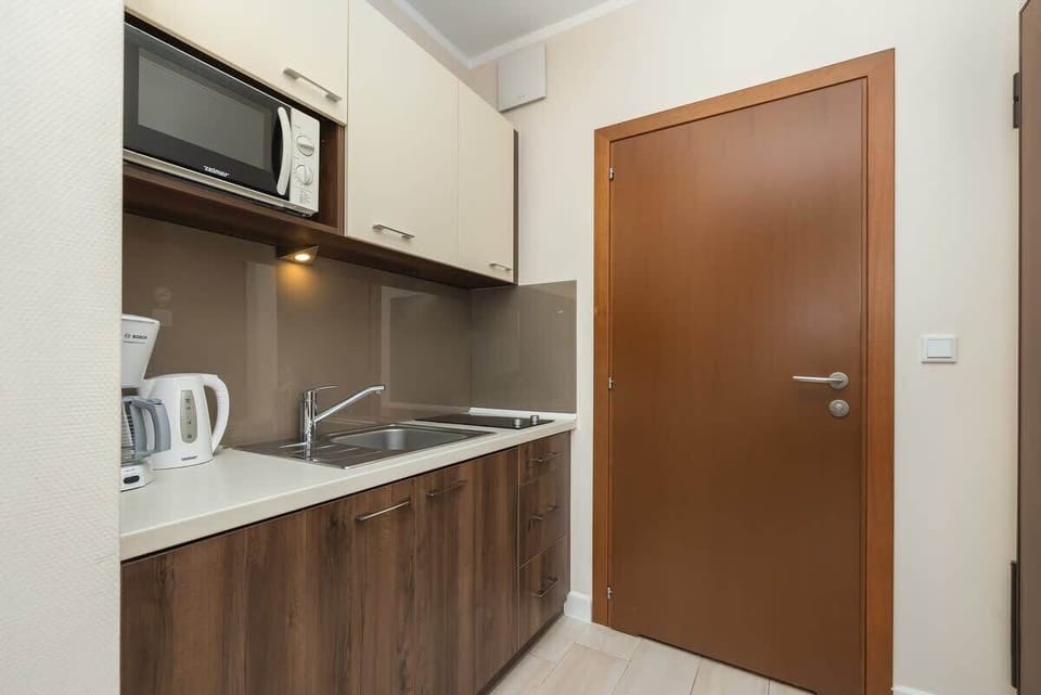 The sleek design of the kitchenette blending seamlessly with the living area.