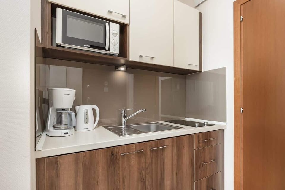 Cook and dine in style with the modern kitchenette and dining area.