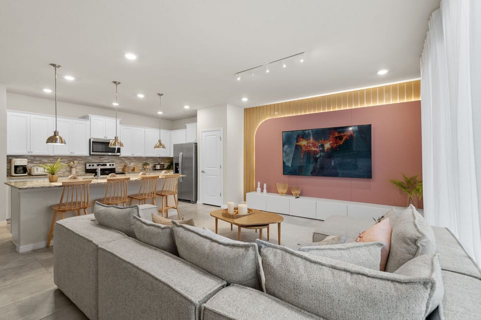 Same living room, different perspective, with open-concept kitchen.
