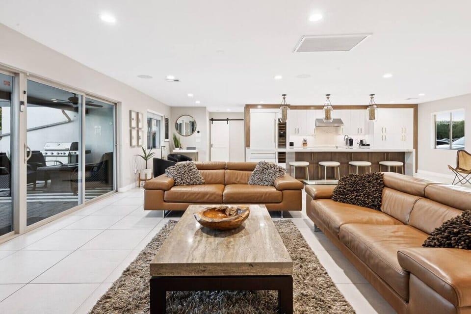 Open living area with leather seating and full views of the kitchen.