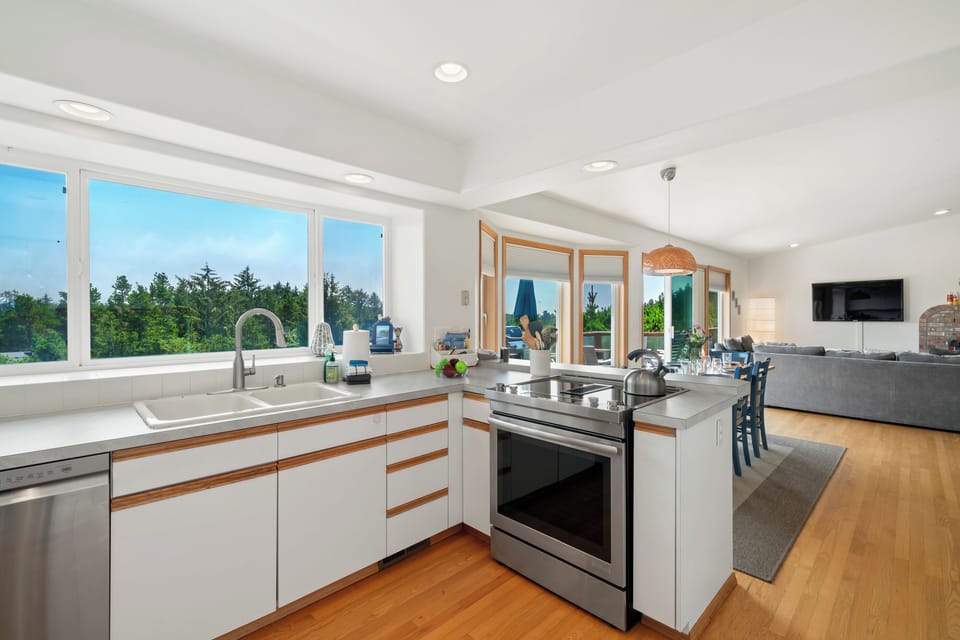 First floor with 3 bedrooms, kitchen, dining, living area, and access to outdoor space and garage. 
Living room with pellet stove, streaming TV. Kitchen with lots of counter space and storage.