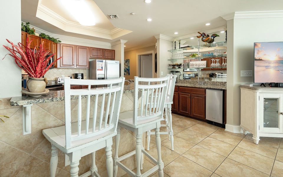 Enjoy casual conversations at the charming breakfast bar, soaking in the inviting coastal vibe