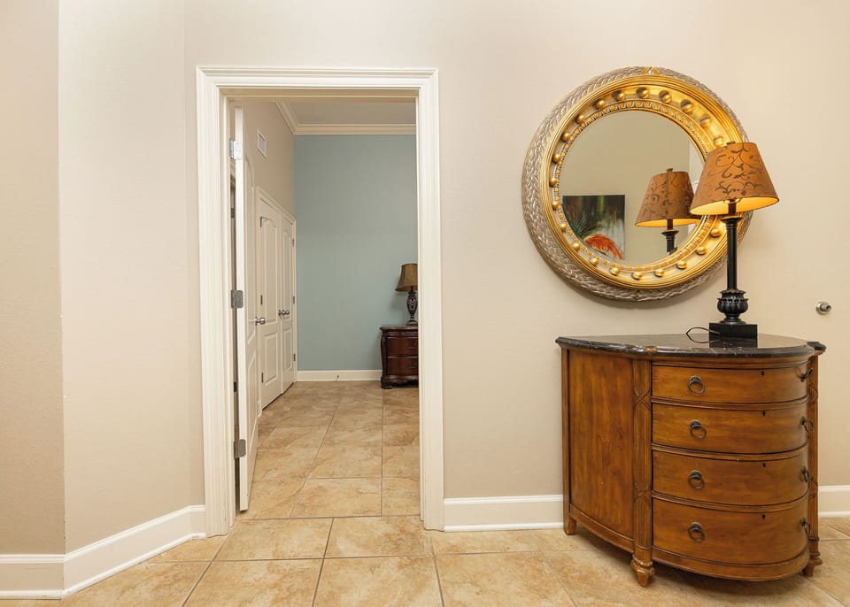 Step into this entryway, where warm wood tones and artistic accents set the stage for your relaxing beach getaway
