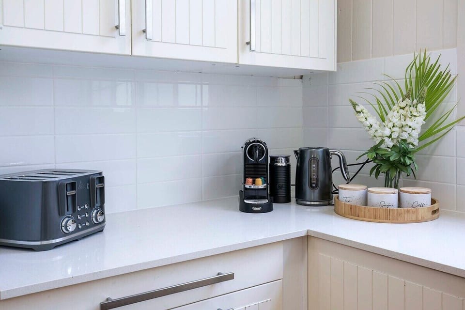 Kitchen cooking zone with appliance setup and breakfast bench for 4.