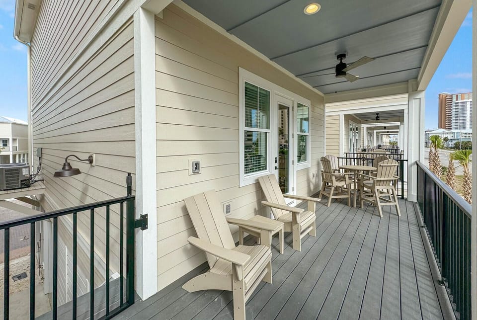 Classic Adirondack chairs and a charming table setting invite you to enjoy the gentle sea breeze on the veranda while sipping your favorite beverage.