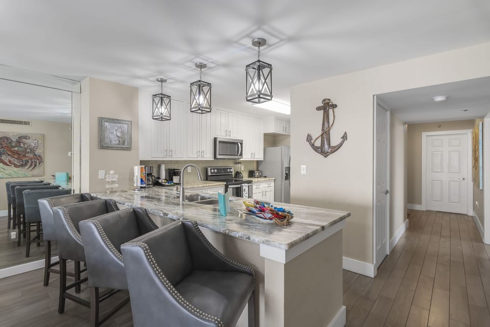 Remodeled Kitchen with granite countertops, stainless appliances - cook delicious meals and dine while overlooking the Gulf of Mexico!