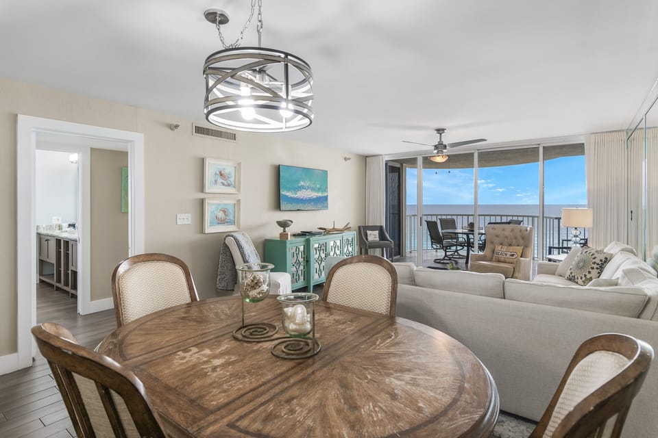 This 3BR/3 BA updated condo features a bright and open living and dining space with tall ceiling, Gulf views, and plenty of seating around a large Smart TV for all your streaming needs.